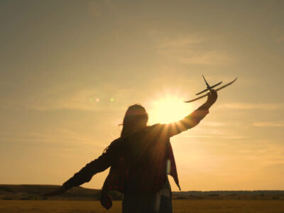 Happy,Girl,Runs,With,A,Toy,Airplane,On,A,Field